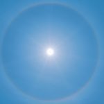 blue sky with white sun