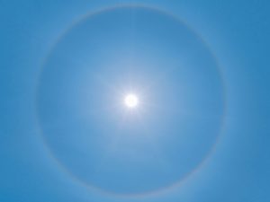 blue sky with white sun